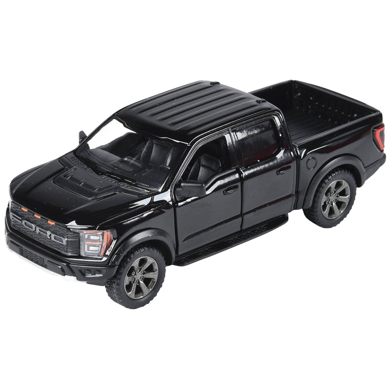 Black diecast Ford F-150 Raptor pickup truck model on white background