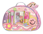 Pink makeup kit in groovy flower patterned case with cosmetics and smiley face patch