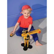 Child playing with yellow wooden crane construction toy on floor