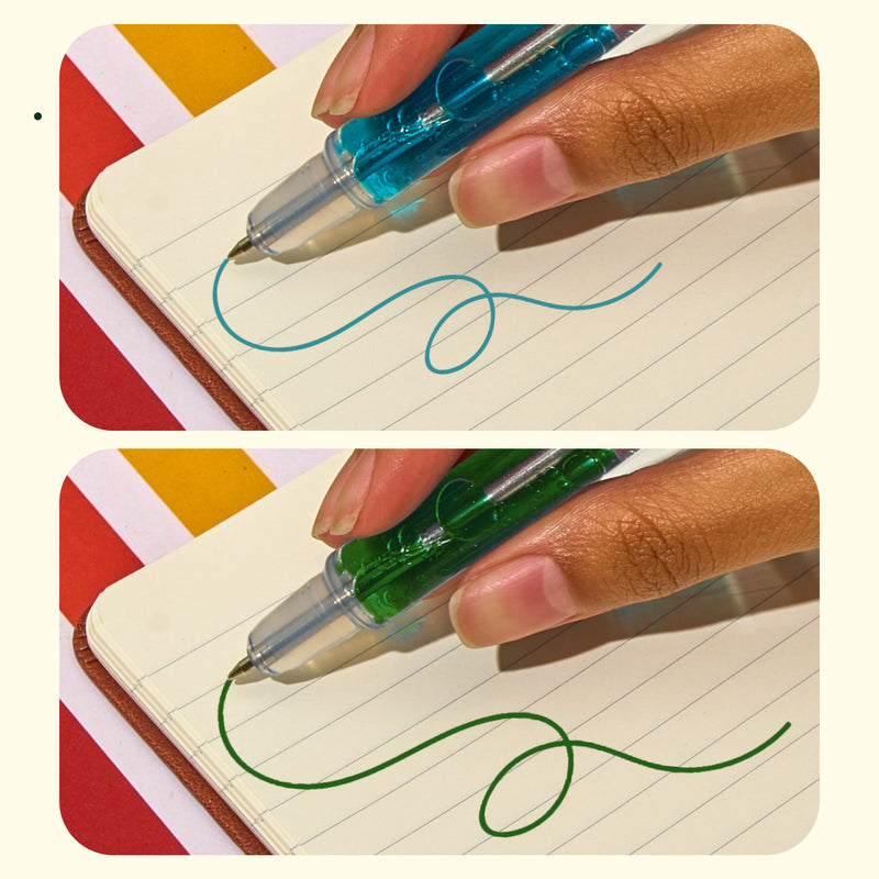 Hand using blue and green scented lava pens writing on lined notebook paper