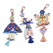 DIY butterfly craft keychains with floral patterns and colorful tassels by DJECO