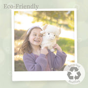 Young girl holding white Highland cow plush toy outdoors in natural lighting