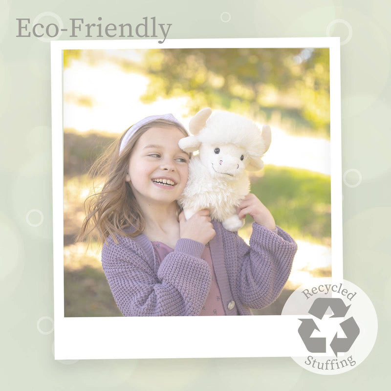 Young girl holding white Highland cow plush toy outdoors in natural lighting