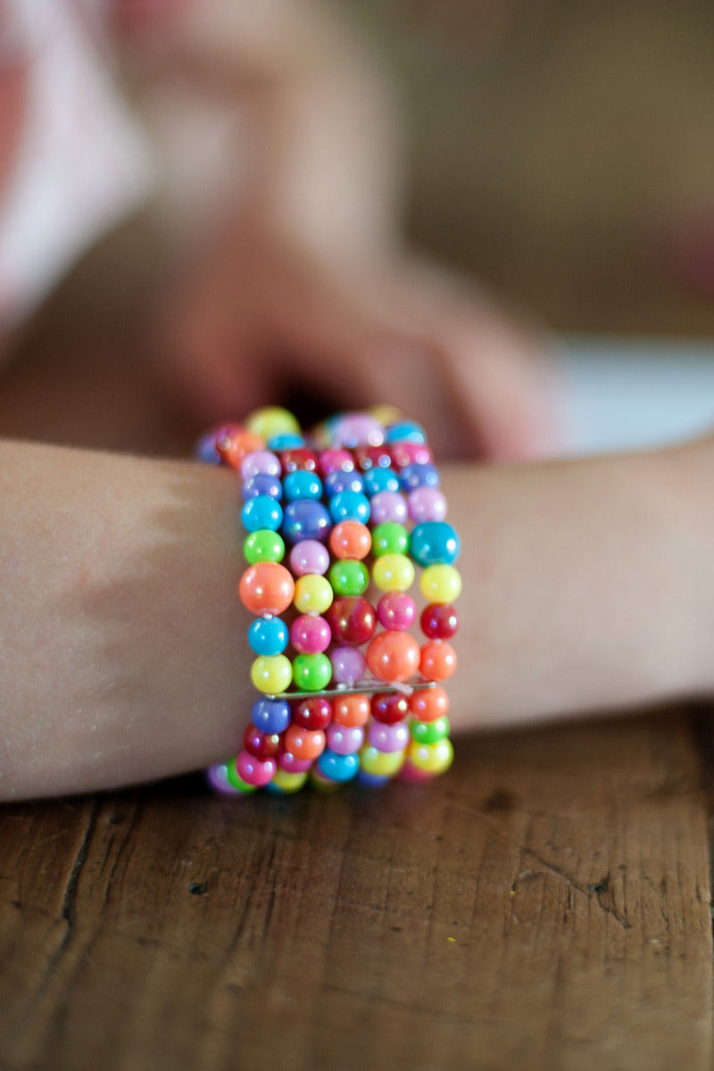 Colorful beaded bracelet with rainbow gumballs worn on wrist