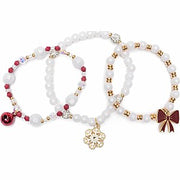Three holiday-themed beaded bracelets with red, white, gold beads and charms