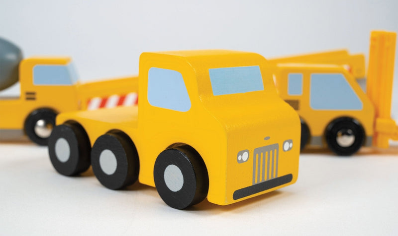 Yellow wooden construction truck transporter toy set with black wheels on white background