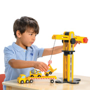 Child playing with yellow Mentari Construction Transporter crane and truck toy set