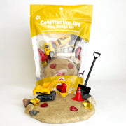 Construction Dig Play Dough Kit with vehicles, tools, and play dough on white background