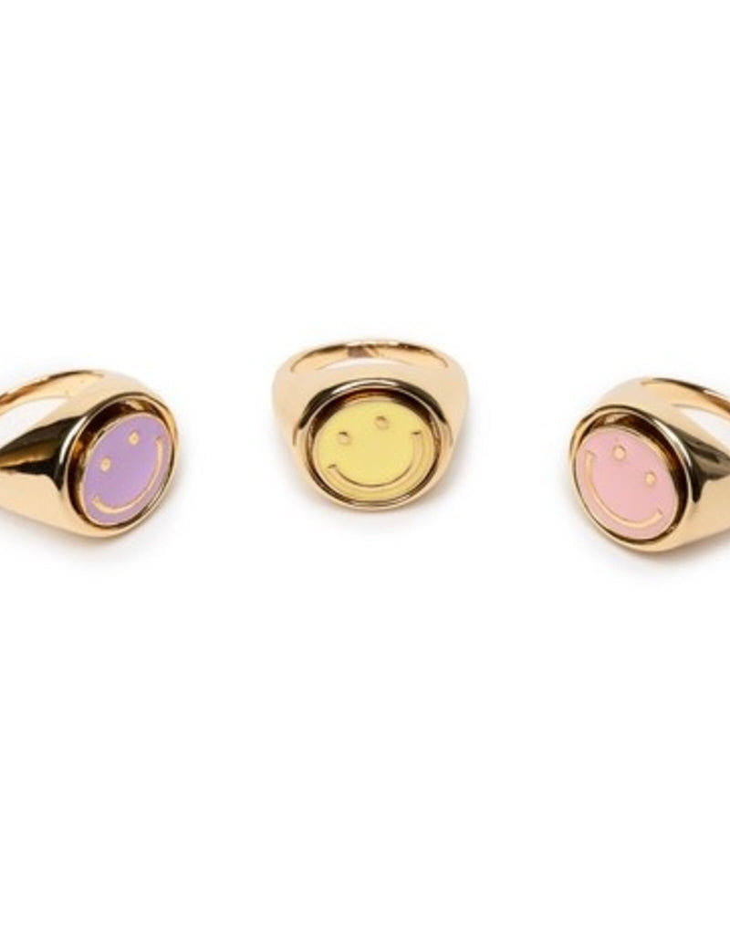 Three gold spinner rings with colorful smiley face designs on white background