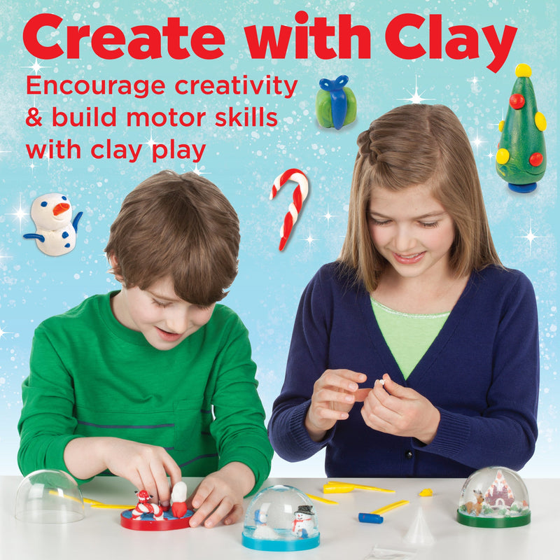 Two children making clay snow globes with holiday decorations and craft supplies