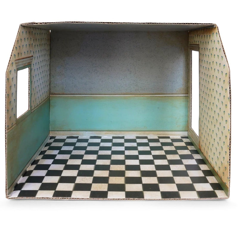 Cardboard dollhouse room interior with checkered floor and floral wallpaper