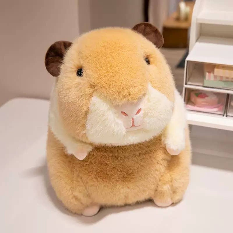 Tan capybara plush toy with white belly sitting on white surface near shelving