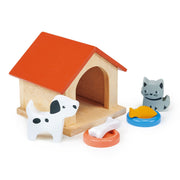Wooden dog house with orange roof, white spotted dog, gray cat, food bowls and bone toy