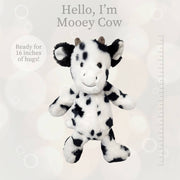 Black and white spotted cow plush toy with ruler showing 16 inch size