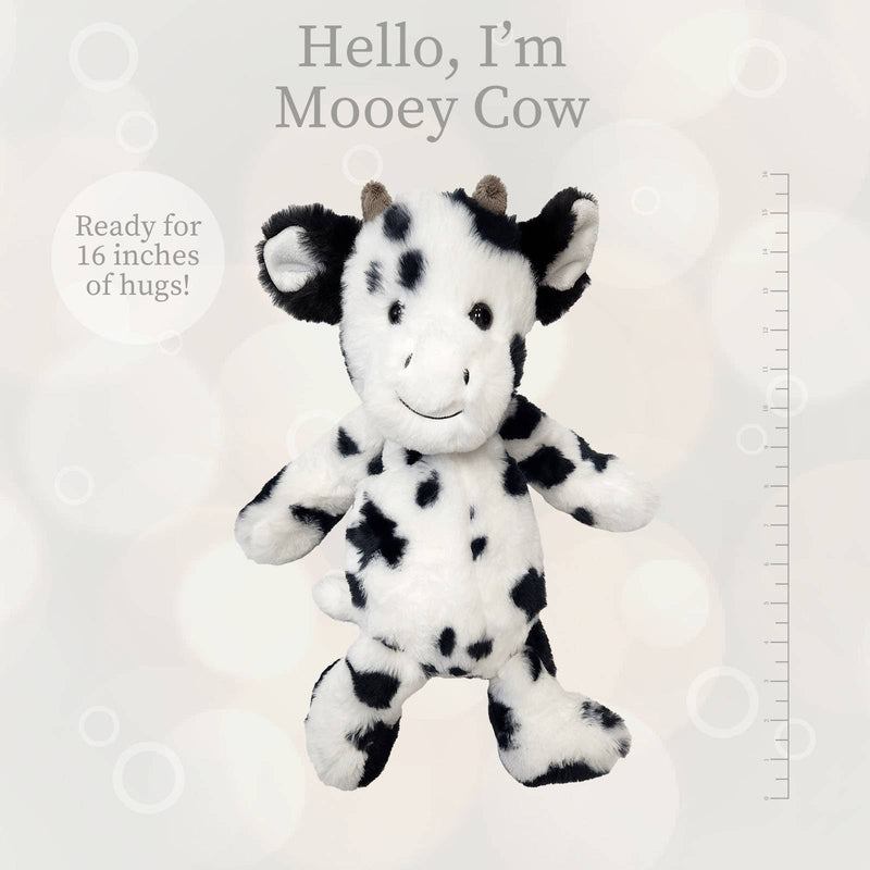 Black and white spotted cow plush toy with ruler showing 16 inch size