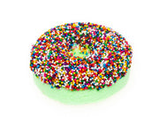 Green donut-shaped bath bomb covered in colorful rainbow sprinkles on white background