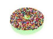 Green donut-shaped bath bomb covered in colorful rainbow sprinkles on white background