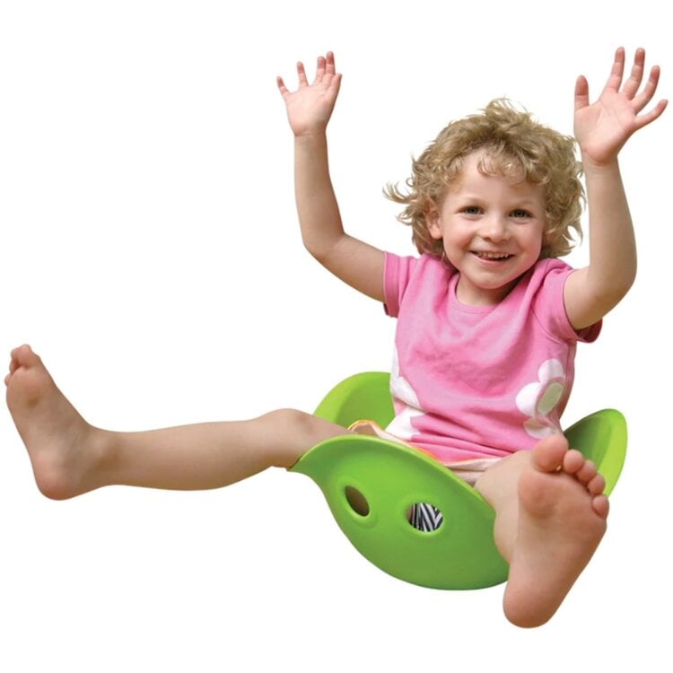 Happy child playing with green Bilibo toy, sitting and raising hands joyfully