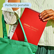 Person carrying red Lifelines FlowArt dot-by-letter Americana notebook in green tote bag