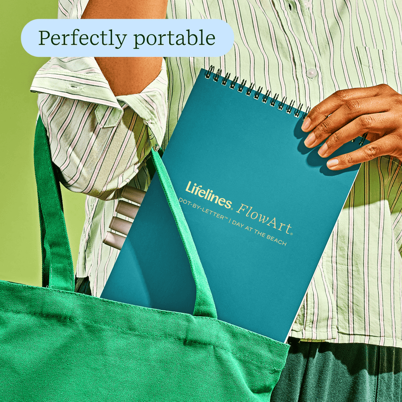 Person carrying teal Lifelines FlowArt notebook in green tote bag