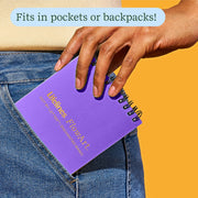 Purple FlowArt Mini notebook being pulled from jeans pocket showing portability