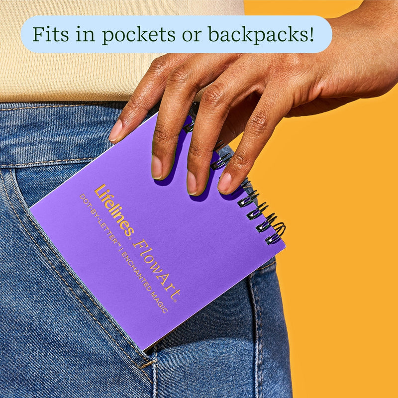 Purple FlowArt Mini notebook being pulled from jeans pocket showing portability