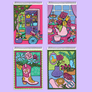 Four spiral-bound FlowArt coloring notebooks featuring vibrant floral illustration covers on lavender background