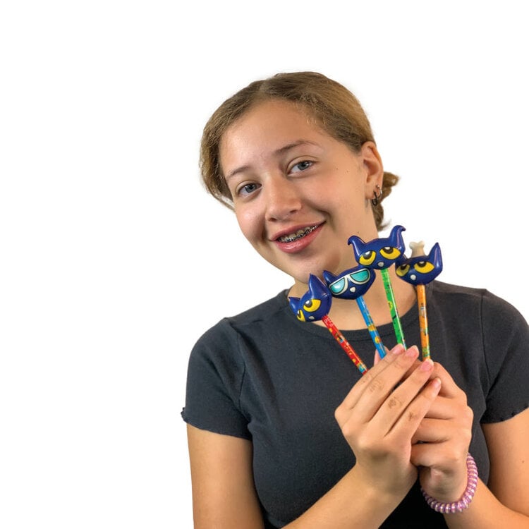 Young girl with braces holding three blue Pete the Cat squishy top pens with different colored barrels