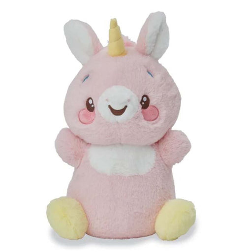 Pink unicorn plush toy with yellow horn and hooves, white belly, sitting pose