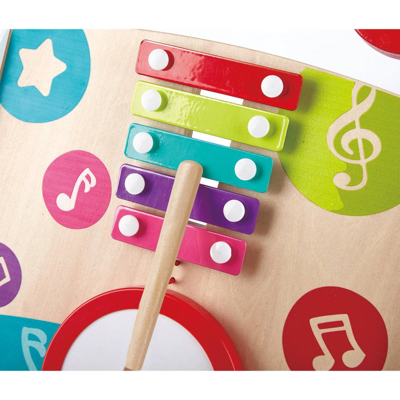 Close-up of colorful wooden xylophone with mallet on Hape musical toy activity board