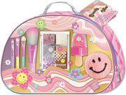 Pink groovy flower beauty bag with makeup brushes eyeshadow palette lip gloss and smiley face patch