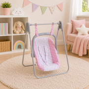Pink polka dot baby doll swing carrier on grey metal frame in pastel nursery room