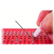 Close-up of red magnetic drawing board with stylus creating magnetic pattern