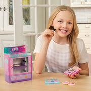Girl applying makeup using Make It Real Bakery Beautiful Cosmetics playset in kitchen setting