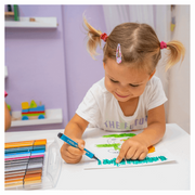 Young girl using colorful markers to draw at white table in purple room