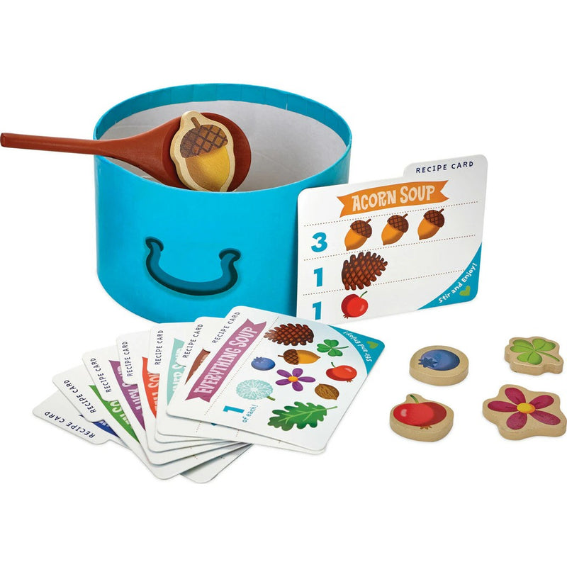 Acorn Soup children's cooking playset with blue pot, wooden spoon, recipe cards, and ingredient tokens.