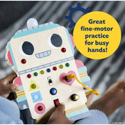 Child playing with colorful robot-shaped sensory board with buttons switches and fine motor activities