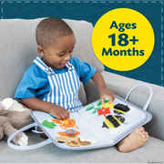 Child playing with My Busy Tote activity board on couch, ages 18+ months