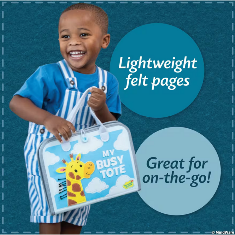 Child holding My Busy Tote featuring giraffe design with blue and white striped outfit