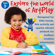 Child wearing yellow art smock using Little Creatives ArtPlay Activity Set with crayons and coloring pages