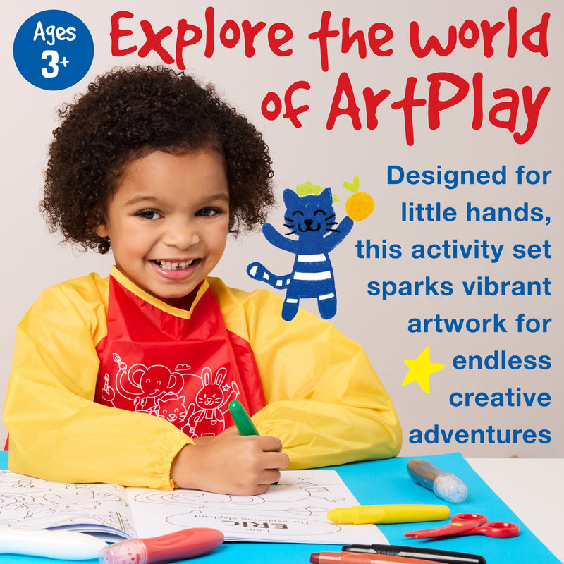 Child wearing yellow art smock using Little Creatives ArtPlay Activity Set with crayons and coloring pages