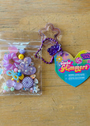 Gacha Glimmers candy-themed collectible toys with colorful beads and charms in clear packaging