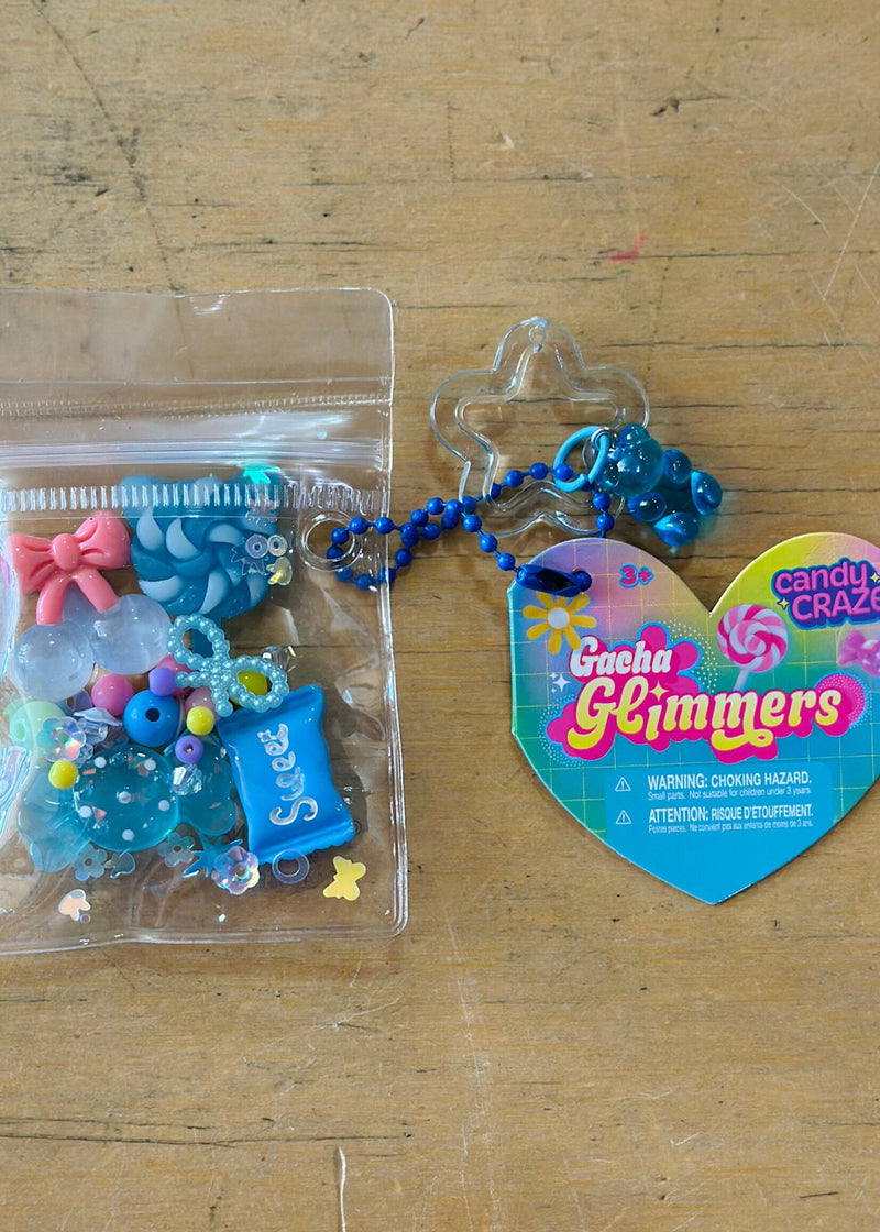 Gacha Glimmers Candy Craze collectible toys with blue beaded keychain and colorful charms displayed