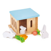 Wooden rabbit hutch toy with blue roof and white rabbits with vegetables