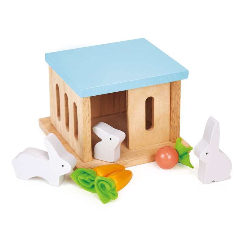 Wooden rabbit hutch toy with blue roof and white rabbits with vegetables