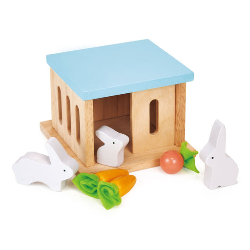 Wooden rabbit hutch toy with blue roof and white rabbits with vegetables