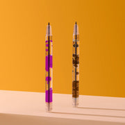 Two clear pens with purple and brown decorative elements on orange background