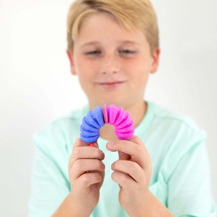 Child holding blue and pink Krumples fidget toy showing bendable accordion design