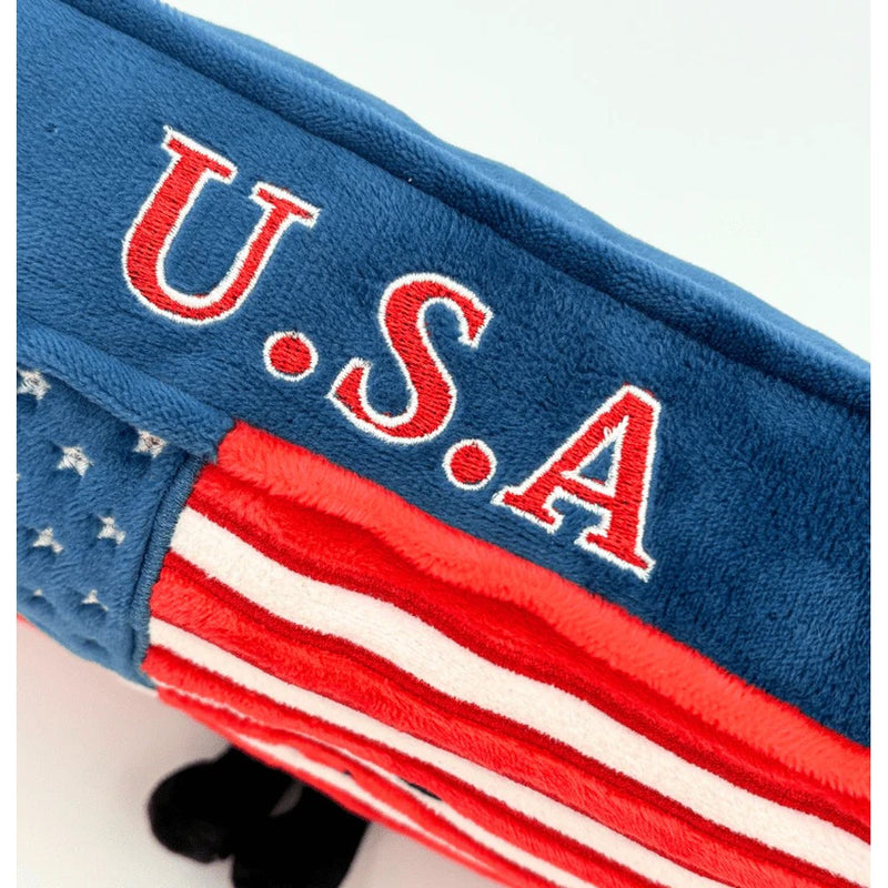 Close-up detail of blue plush USA stuffed product showing embroidered U.S.A text and flag stripes