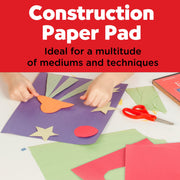 Construction paper pad shown in lifestyle setting with hands creating colorful paper crafts